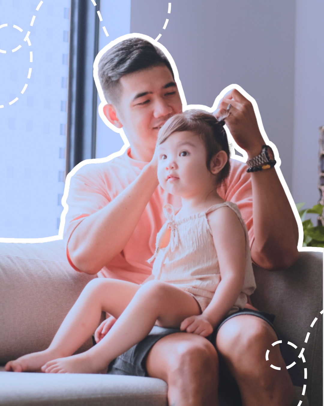 dad and baby girl sitting together and dad is doing her hair