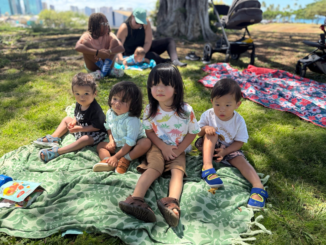 toddlers sitting together on ground