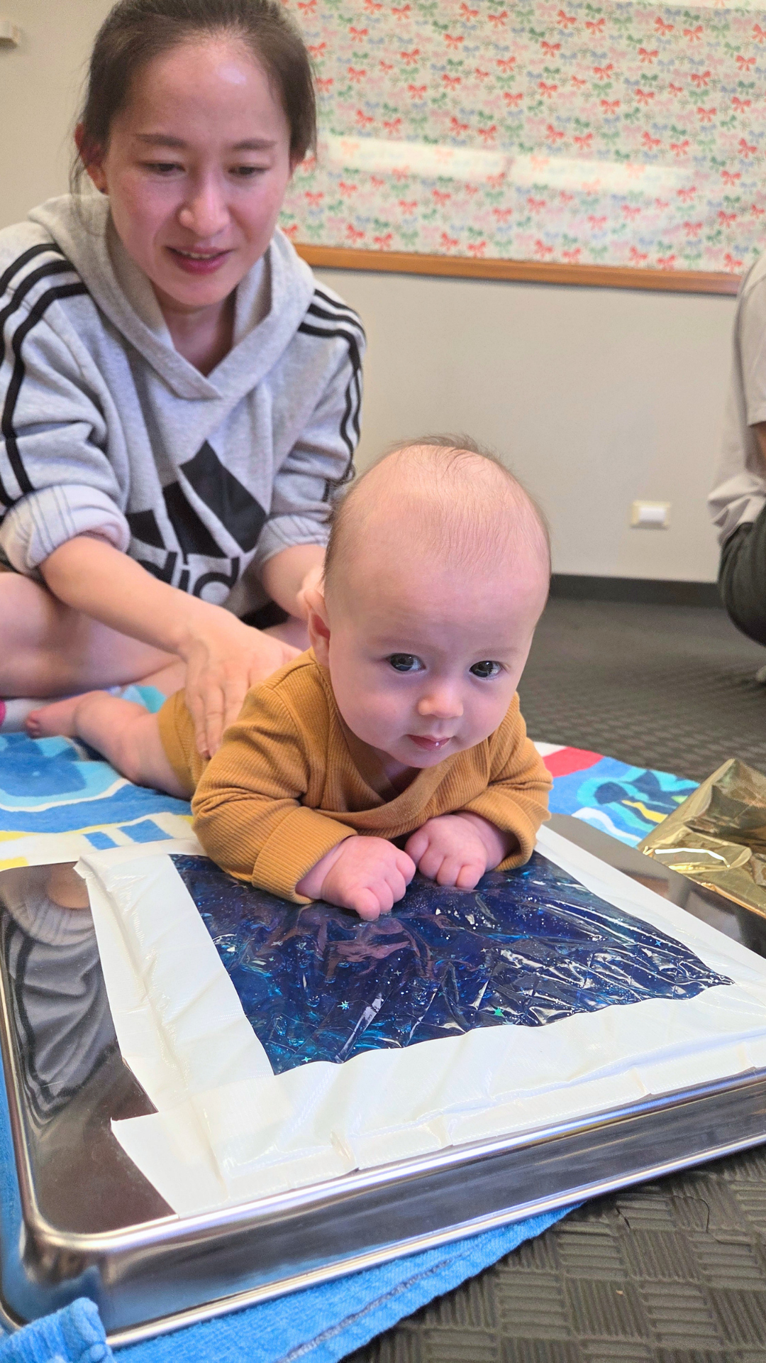 mom and baby doing tummy time on a sensory mat