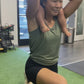 a mom doing lunges at the gym with her toddler on her shoulders